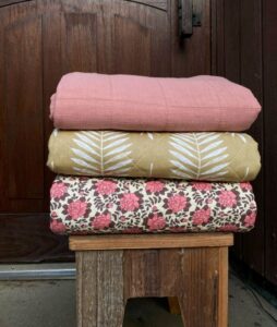 tikattu torkkupeitto eri väreissä tuolilla